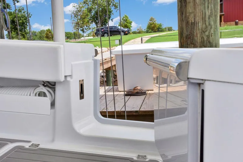 Slide: The Image of 2022 Freeman 47T boat interior with dock view, featuring sleek white design and clear skies. - 25