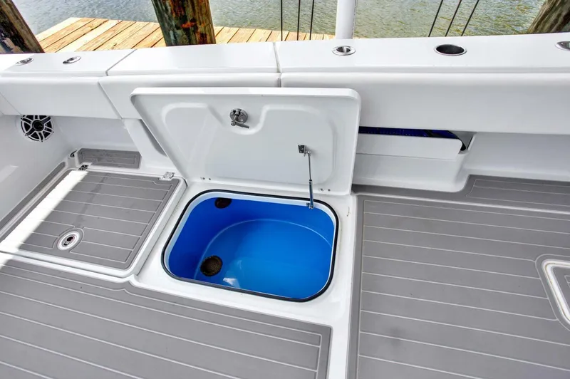 Slide: The Image of Open storage compartment on 2022 Freeman 47T boat deck with blue interior. - 28