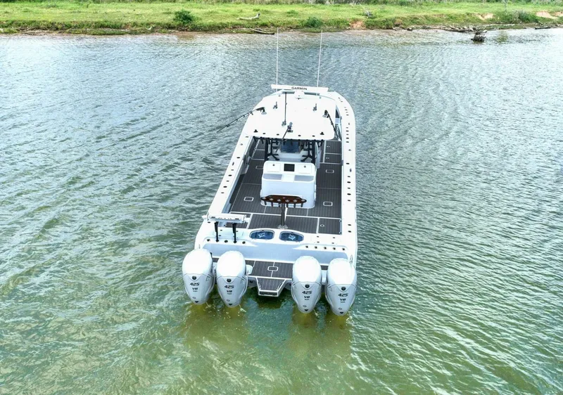 Slide: The Image of 2022 Freeman 47T boat with four engines on calm water. - 3