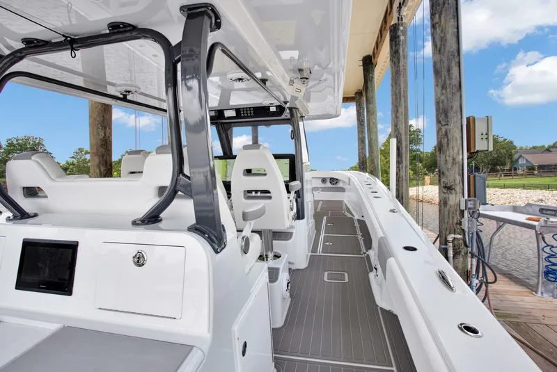 Slide: The Image of 2022 Freeman 47T boat interior with sleek design and modern features, docked by the shore. - 30