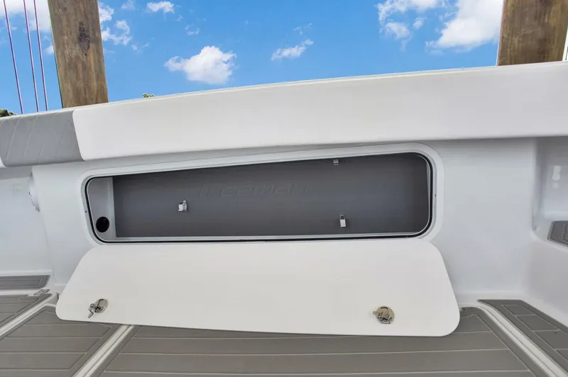 Slide: The Image of Freeman 47T 2022 boat storage compartment with open hatch under blue sky. - 31