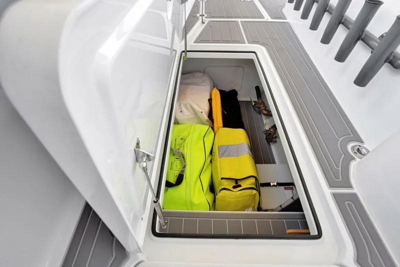 Slide: The Image of Open storage compartment on 2022 Freeman 47T boat with safety gear. - 32
