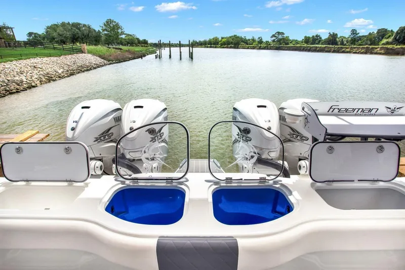 Slide: The Image of 2022 Freeman 47T boat with dual engines and open storage compartments on a serene river. - 37