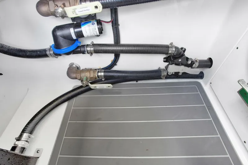Slide: The Image of Freeman 47T 2022 model plumbing system with hoses and fittings in a boat compartment. - 43