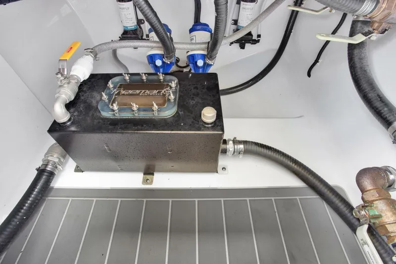 Slide: The Image of Engine compartment of a 2022 Freeman 47T boat, featuring hoses and mechanical components. - 48
