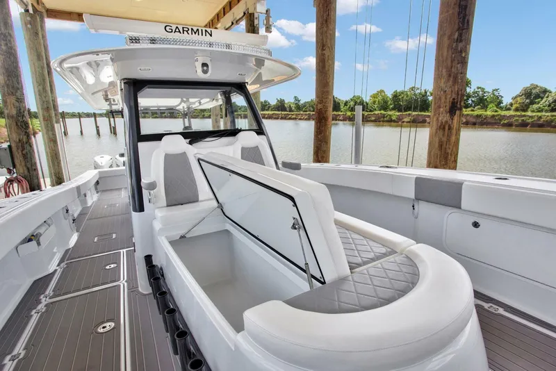 Slide: The Image of Freeman 47T 2022 boat interior with open storage, docked by a river. - 7