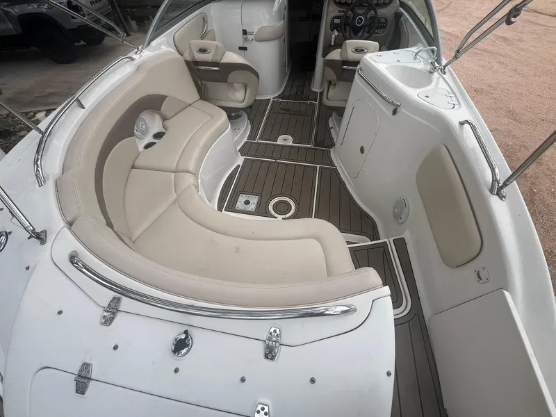 Slide: The Image of 2006 Chaparral Sunesta 254 boat interior with beige seating and sleek design. - 12