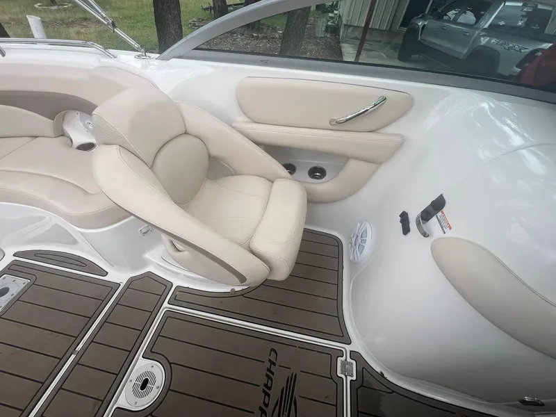Slide: The Image of 2006 Chaparral Sunesta 254 boat interior with beige seating and wood-patterned flooring. - 13