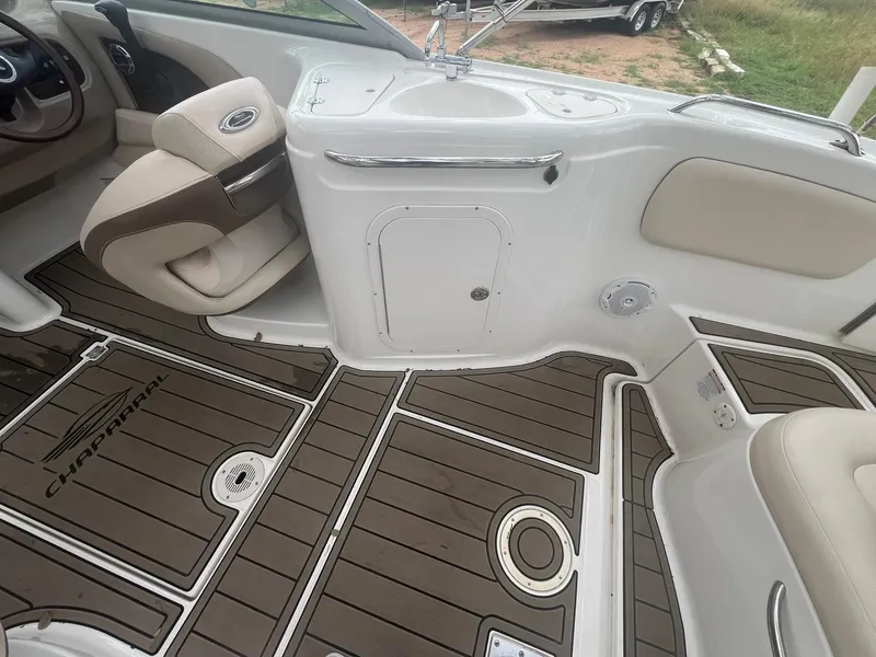 Slide: The Image of 2006 Chaparral Sunesta 254 boat interior with brown and white seating and flooring. - 15