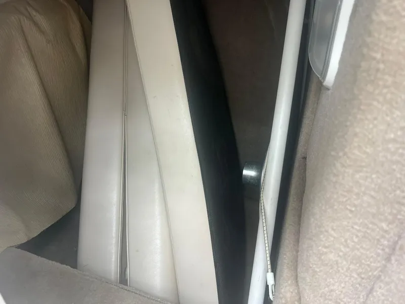 Slide: The Image of 2006 Chaparral Sunesta 254 interior detail with beige upholstery and storage compartment. - 16