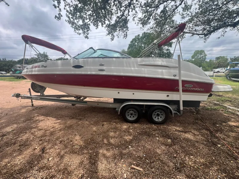 Slide: The Image of 2006 Chaparral Sunesta 254 boat on trailer, parked outdoors under trees. - 2