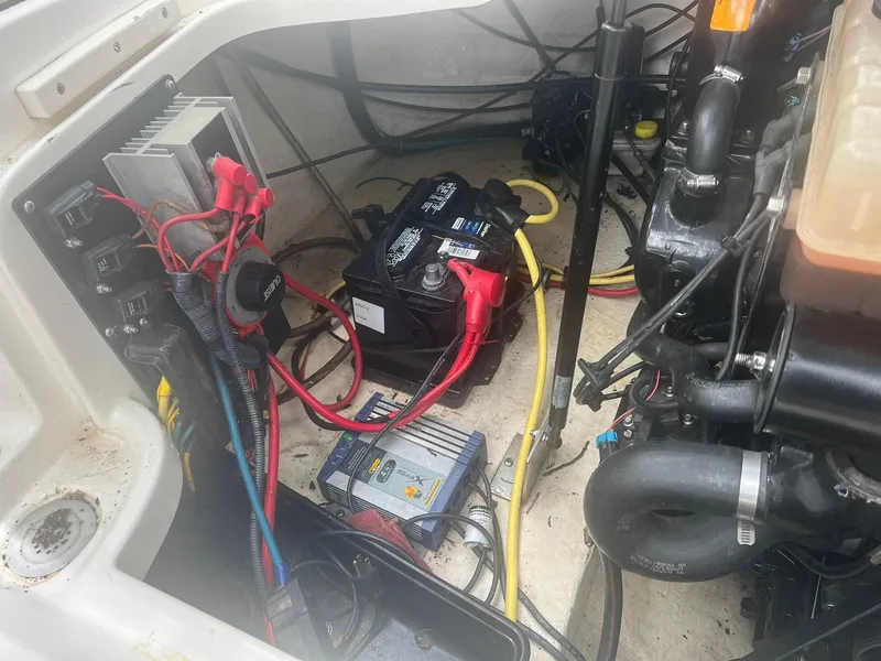 Slide: The Image of Engine compartment of a 2006 Chaparral Sunesta 254 with visible wiring and battery. - 21