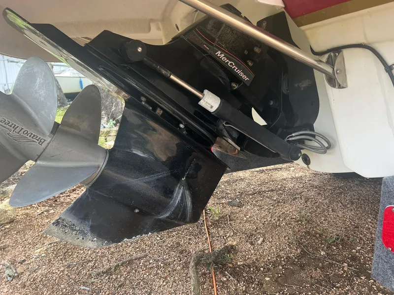 Slide: The Image of 2006 Chaparral Sunesta 254 boat with MerCruiser outdrive and propeller, parked on gravel. - 22