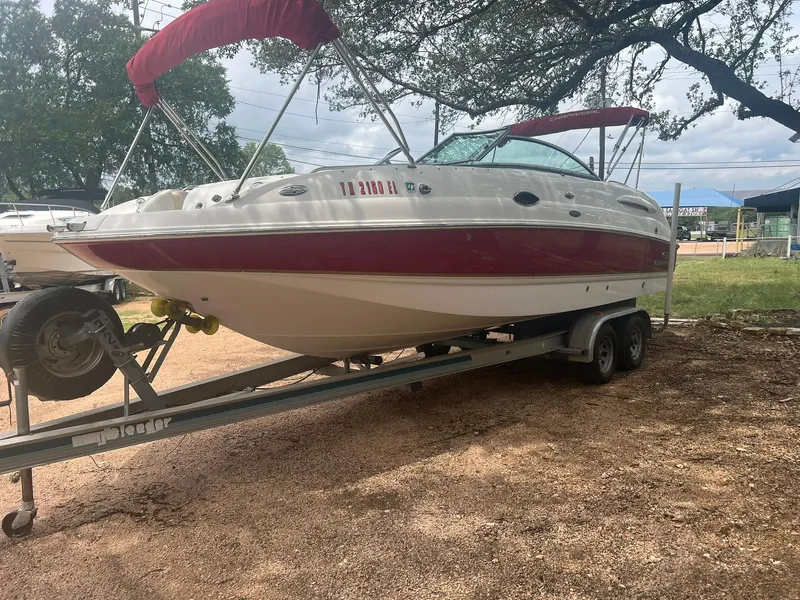 Slide: The Image of 2006 Chaparral Sunesta 254 boat on trailer, red and white design, parked outdoors. - 3