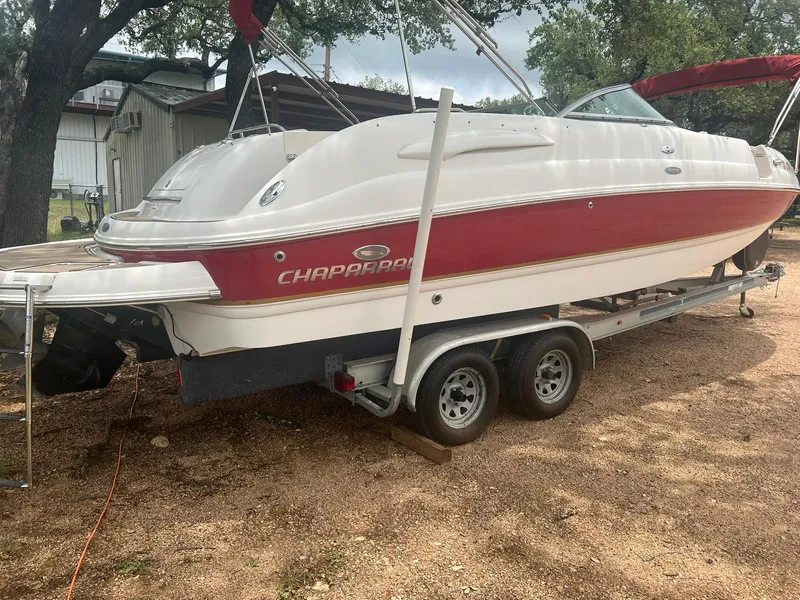 Slide: The Image of 2006 Chaparral Sunesta 254 boat on trailer, red and white design, parked outdoors. - 4
