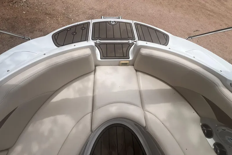 Slide: The Image of 2006 Chaparral Sunesta 254 boat interior with cushioned seating and wood accents. - 8