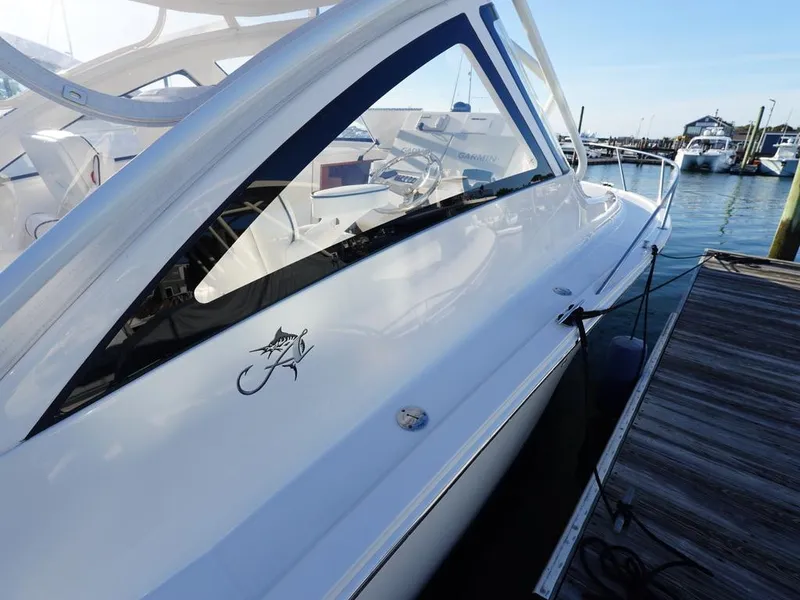 Slide: The Image of 2024 Albemarle 30 Express boat docked at marina, sleek design, white exterior. - 26