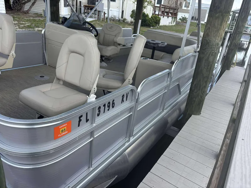 Slide: The Image of 2019 Misty Harbor 2085 Adventure CF pontoon boat docked, featuring beige seating and Florida registration. - 4