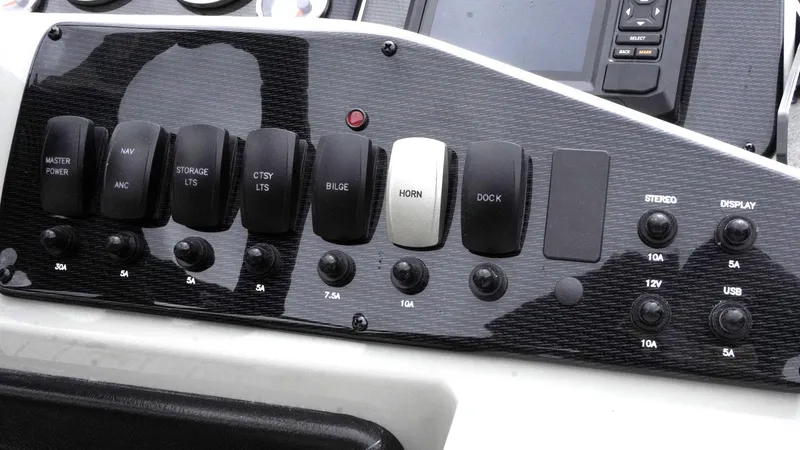 Slide: The Image of Control panel of 2025 SunCatcher Select 322RC boat with labeled switches and buttons. - 20