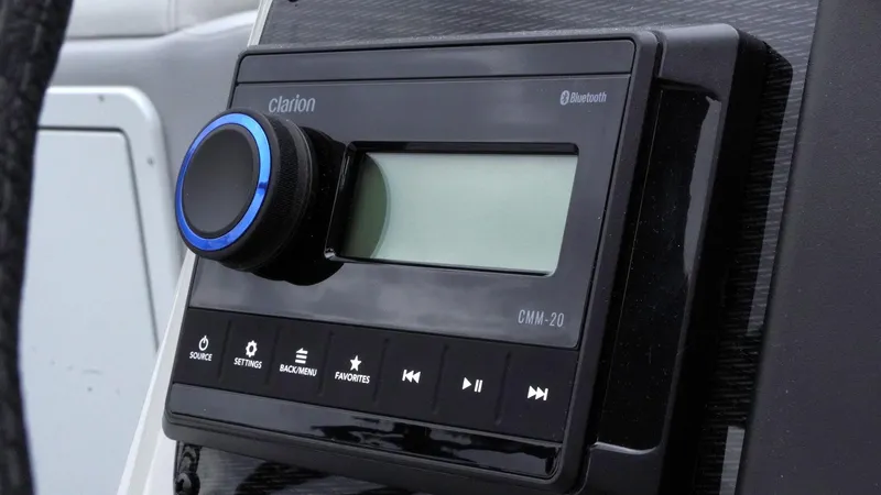 Slide: The Image of Clarion audio system in 2025 SunCatcher Select 322RC boat, featuring Bluetooth connectivity. - 21