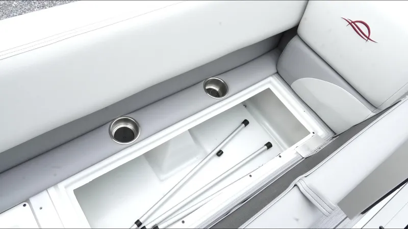Slide: The Image of 2025 SunCatcher Select 322RC boat interior with storage compartment and cup holders. - 27