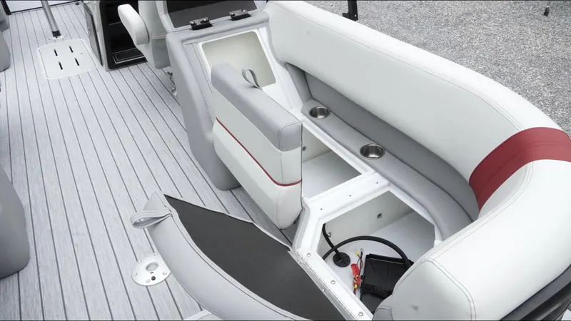 Slide: The Image of 2025 SunCatcher Select 322RC boat interior with open storage compartment and seating. - 29