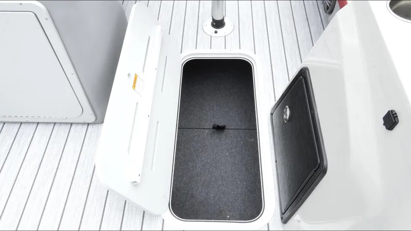 Slide: The Image of Open storage compartment on 2025 SunCatcher Select 322RC boat deck. - 31