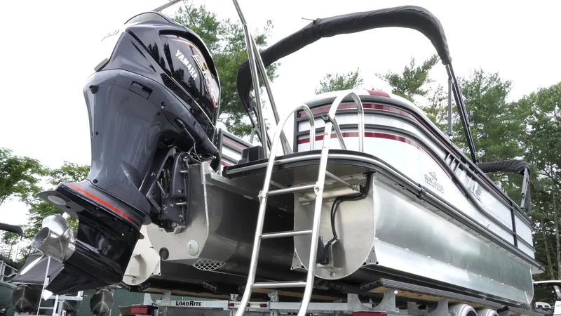 Slide: The Image of 2025 SunCatcher Select 322RC pontoon boat with outboard motor and ladder, on trailer. - 4