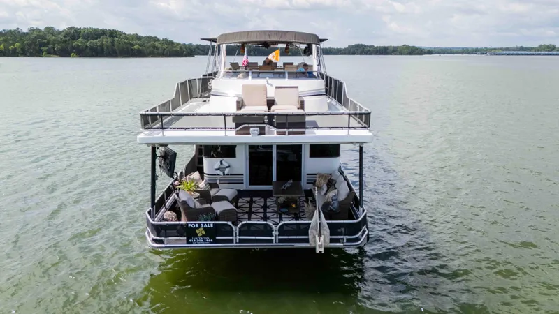 Slide: The Image of 1998 Sumerset houseboat for sale on a lake, featuring spacious decks and modern amenities. - 10