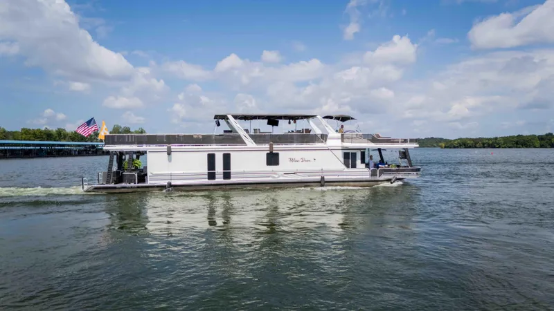 Slide: The Image of 1998 Sumerset houseboat cruising on a lake under a partly cloudy sky. - 20