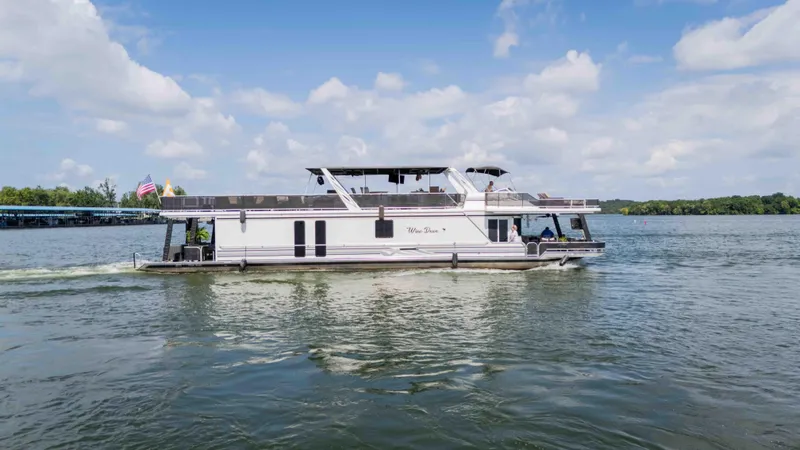 Slide: The Image of 1998 Sumerset houseboat cruising on a lake under a partly cloudy sky. - 21