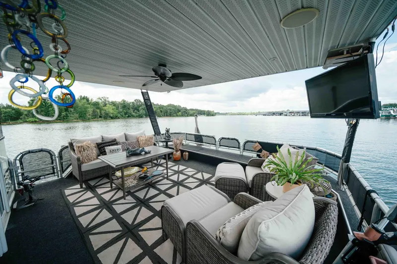 Slide: The Image of Luxurious 1998 Sumerset houseboat deck with cozy seating, TV, and scenic lake view. - 22