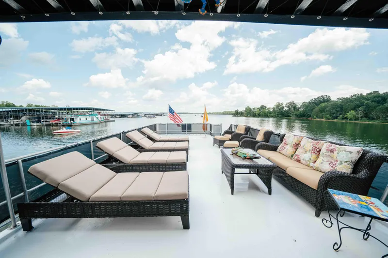 Slide: The Image of Luxurious 1998 Sumerset houseboat deck with lounge chairs and seating, overlooking serene lake views. - 25
