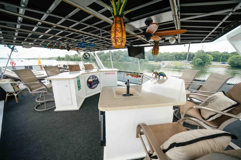 Slide: The Image of Luxurious 1998 Sumerset houseboat interior with bar, seating, and lake view. - 26