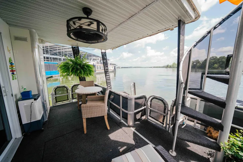 Slide: The Image of 1998 Sumerset houseboat deck with seating, spiral staircase, and lake view. - 31