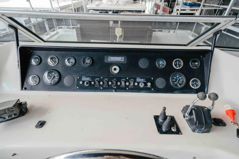 Slide: The Image of 1998 Sumerset houseboat control panel with gauges and levers. - 35