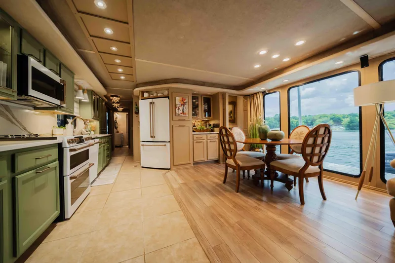 Slide: The Image of Luxurious 1998 Sumerset houseboat interior with modern kitchen and dining area, featuring large windows. - 41