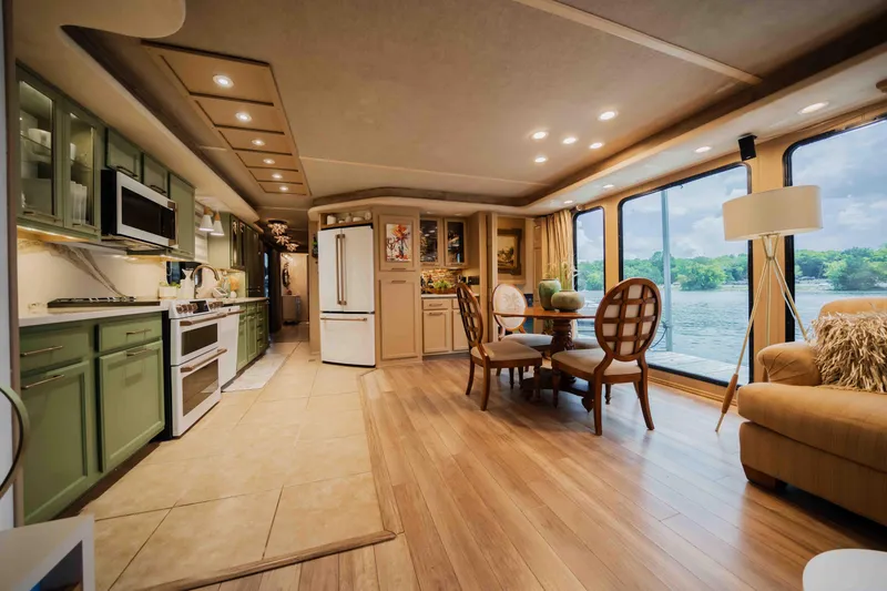 Slide: The Image of Luxurious 1998 Sumerset houseboat interior with modern kitchen, dining area, and scenic water views. - 42