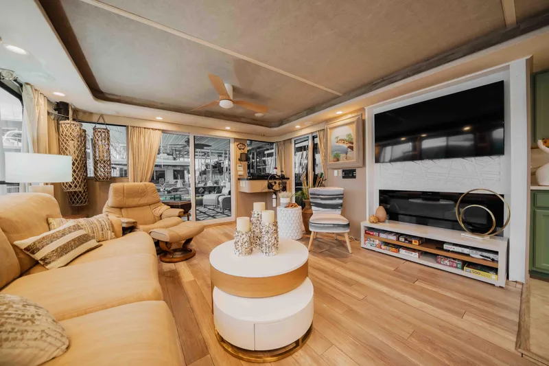 Slide: The Image of Luxurious 1998 Sumerset houseboat interior with modern decor, cozy seating, and large TV. - 43
