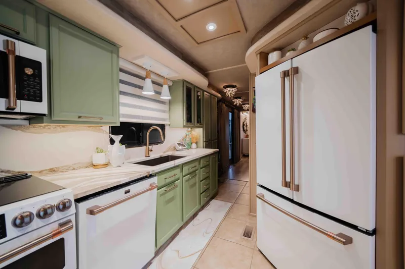 Slide: The Image of Modern kitchen in a 1998 Sumerset houseboat with green cabinets and white appliances. - 46