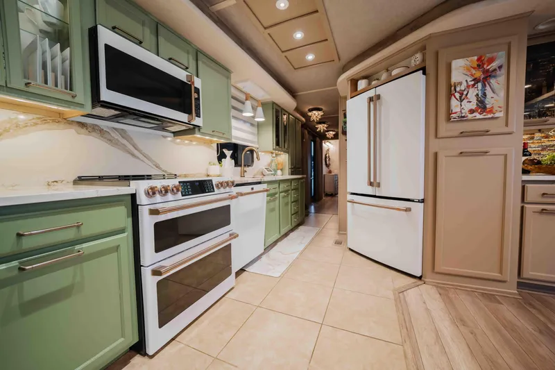Slide: The Image of Modern kitchen interior in a 1998 Sumerset houseboat with green cabinets and white appliances. - 47
