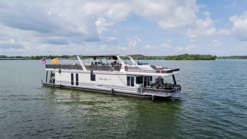 Slide: The Image of 1998 Sumerset houseboat on a lake under a cloudy sky. - 6