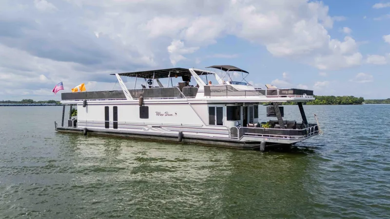 Slide: The Image of 1998 Sumerset houseboat on a lake under a cloudy sky. - 7