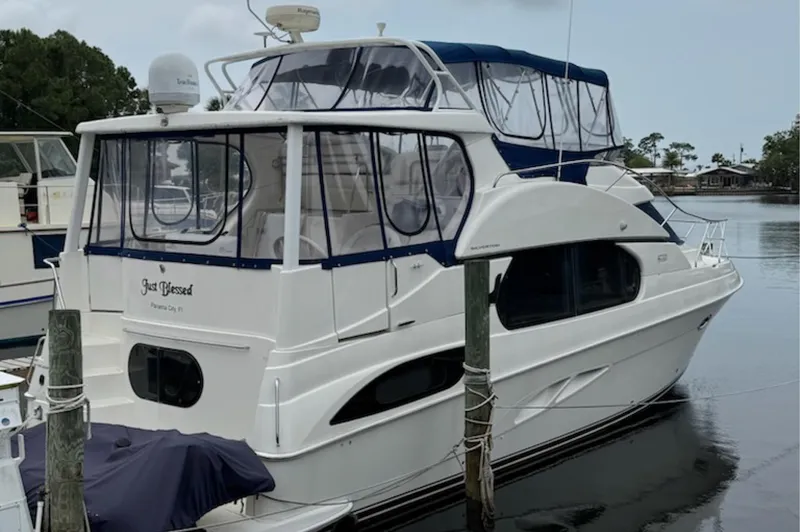 Slide: The Image of 2002 Silverton 43 Motor Yacht docked, featuring sleek design and spacious cabin. - 1