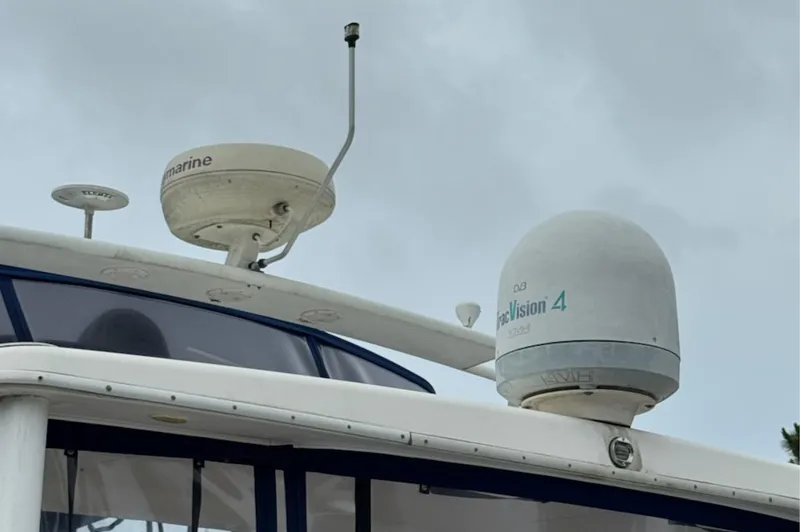 Slide: The Image of Radar and satellite equipment on a 2002 Silverton 43 Motor Yacht against a cloudy sky. - 10