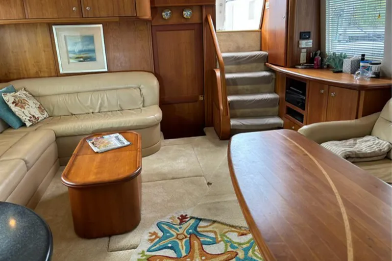 Slide: The Image of Interior of 2002 Silverton 43 Motor Yacht with plush seating and wooden furnishings. - 11