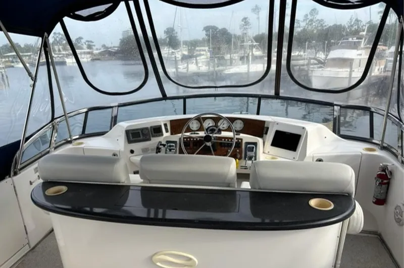 Slide: The Image of 2002 Silverton 43 Motor Yacht helm with panoramic marina view. - 3