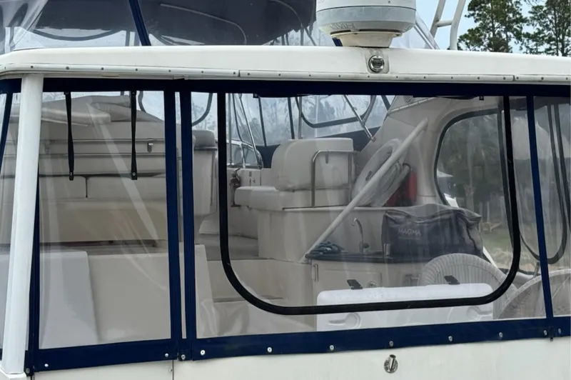 Slide: The Image of 2002 Silverton 43 Motor Yacht interior with clear enclosure and seating area. - 4