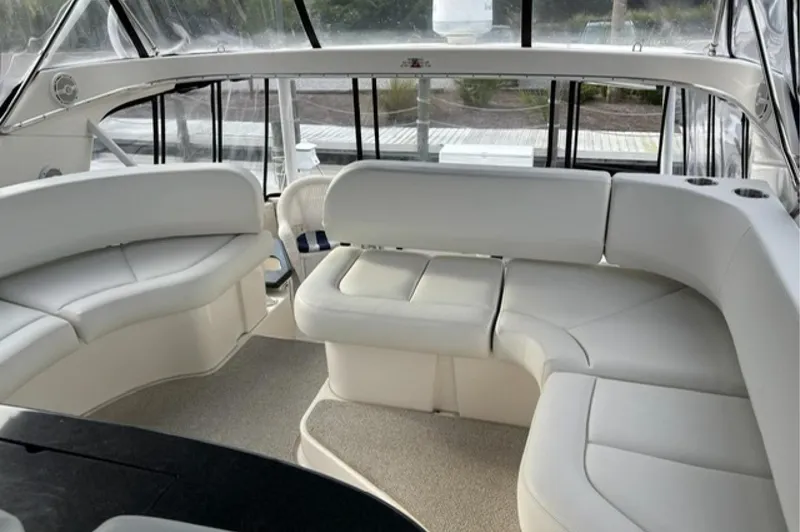 Slide: The Image of Interior of 2002 Silverton 43 Motor Yacht with white leather seating and panoramic windows. - 5