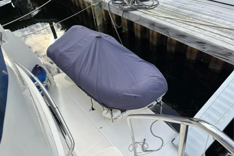 Slide: The Image of 2002 Silverton 43 Motor Yacht with covered equipment on deck, docked at marina. - 9